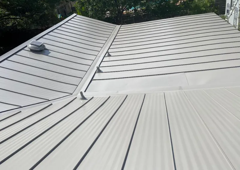 Solar attic fan installed on a metal roof for Roof Ventilation in Galliano
